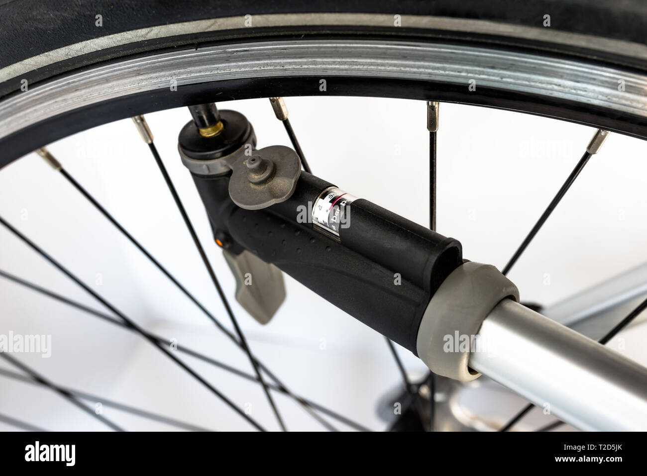 Pumping the bicycle wheel using a hand pump with air pressure indicator