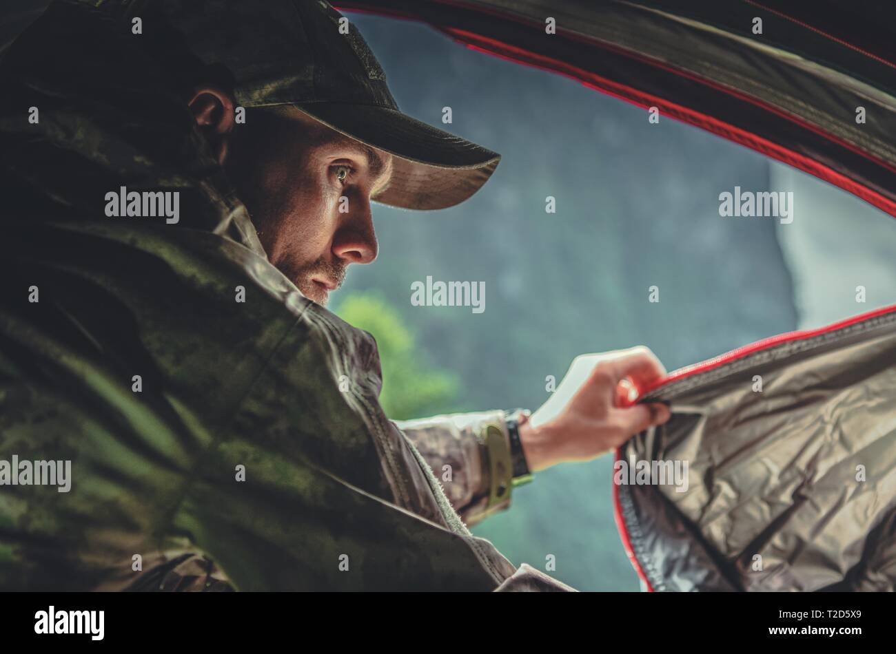 Caucasian Hunter in His 30s in a Tent. Hunting Season. Stock Photo