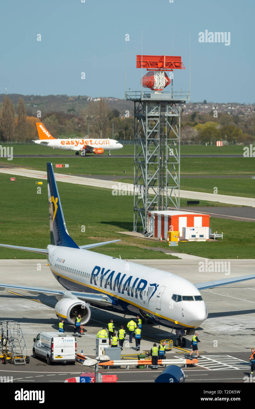 First Ryanair Boeing 737 EI-GJG arriving at parking spot at London Southend Airport, Essex, UK, with waiting ground handlers. New service. easyJet too Stock Photo