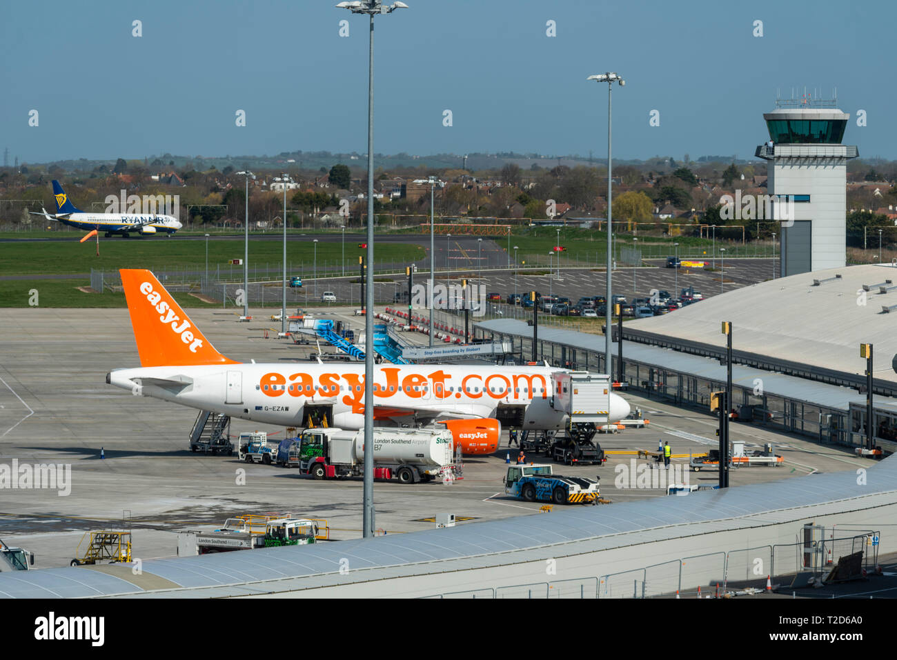 London Southend Airport, Essex, UK, passenger terminal and air traffic control tower with easyJet Airbus on ramp apron and various ground equipment Stock Photo