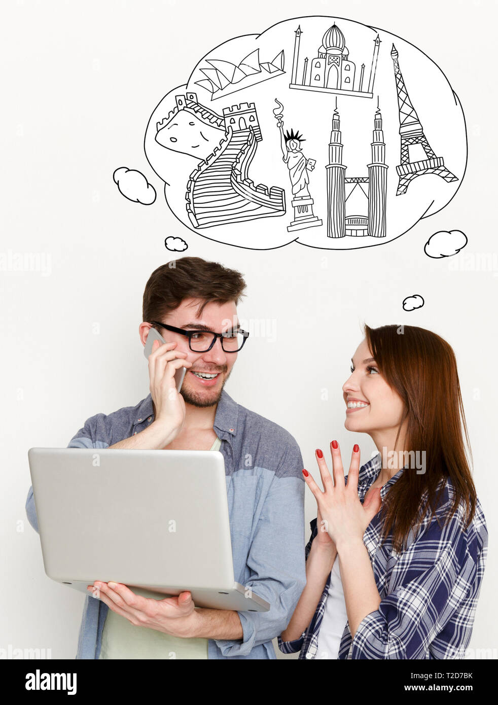 Happy couple choosing tour using laptop at white backround with drawn cloud full of world sights simbols . Travel agency online concept Stock Photo
