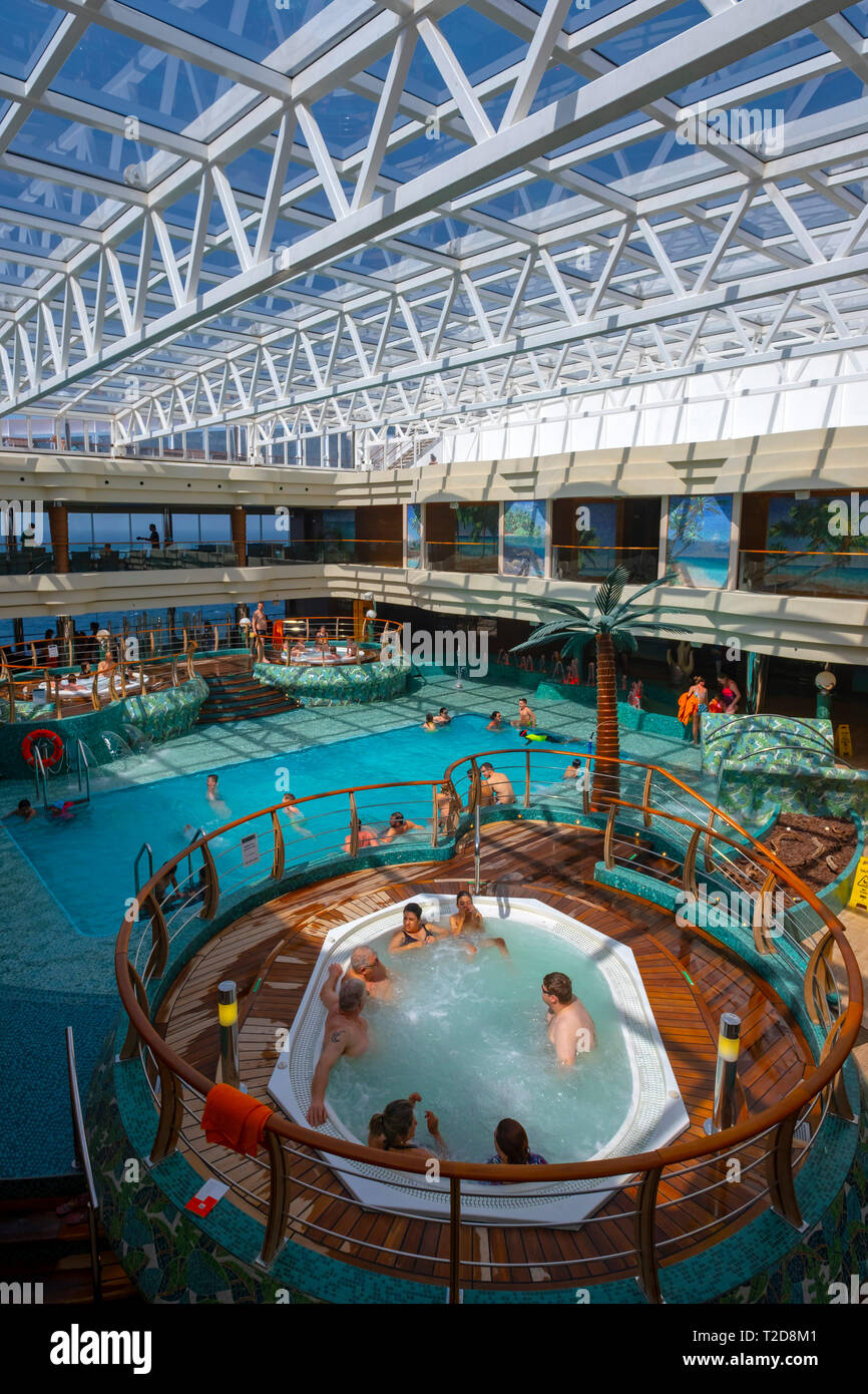 People enjoying the interior swimming pool on the cruise ship MSC Splendida Stock Photo