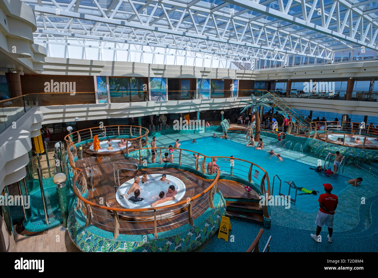 People enjoying the interior swimming pool on the cruise ship MSC Splendida Stock Photo