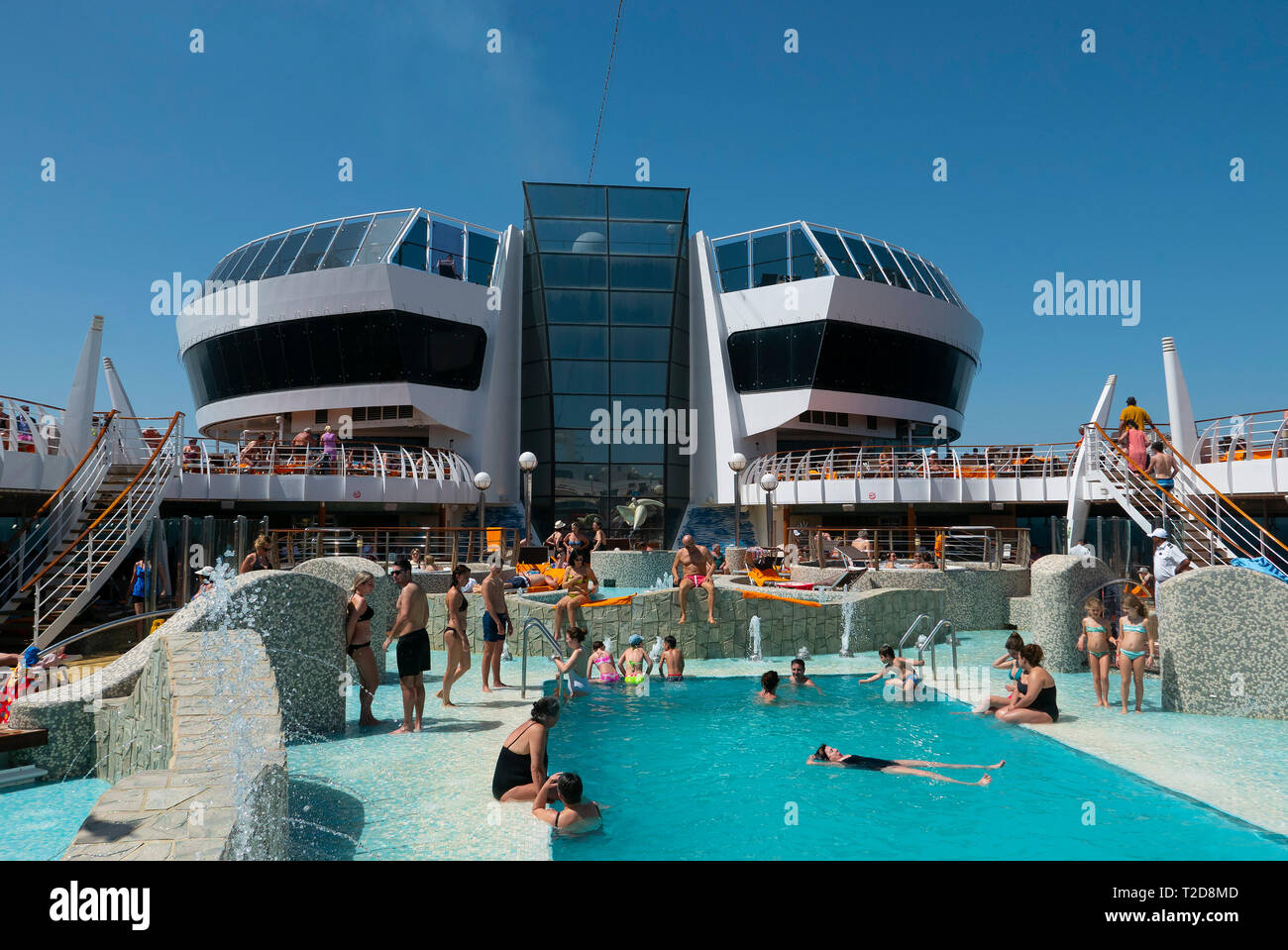 People enjoying the swimming pool on the cruise ship MSC Splendida Stock Photo