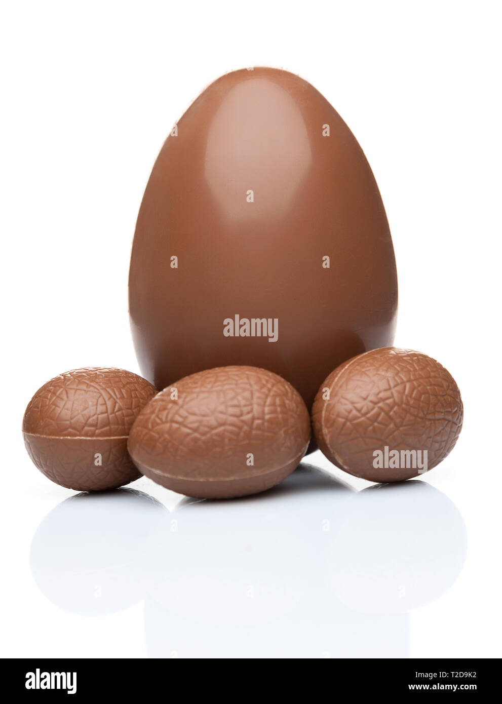 Delicious chocolate Easter eggs and sweets on white background Stock Photo