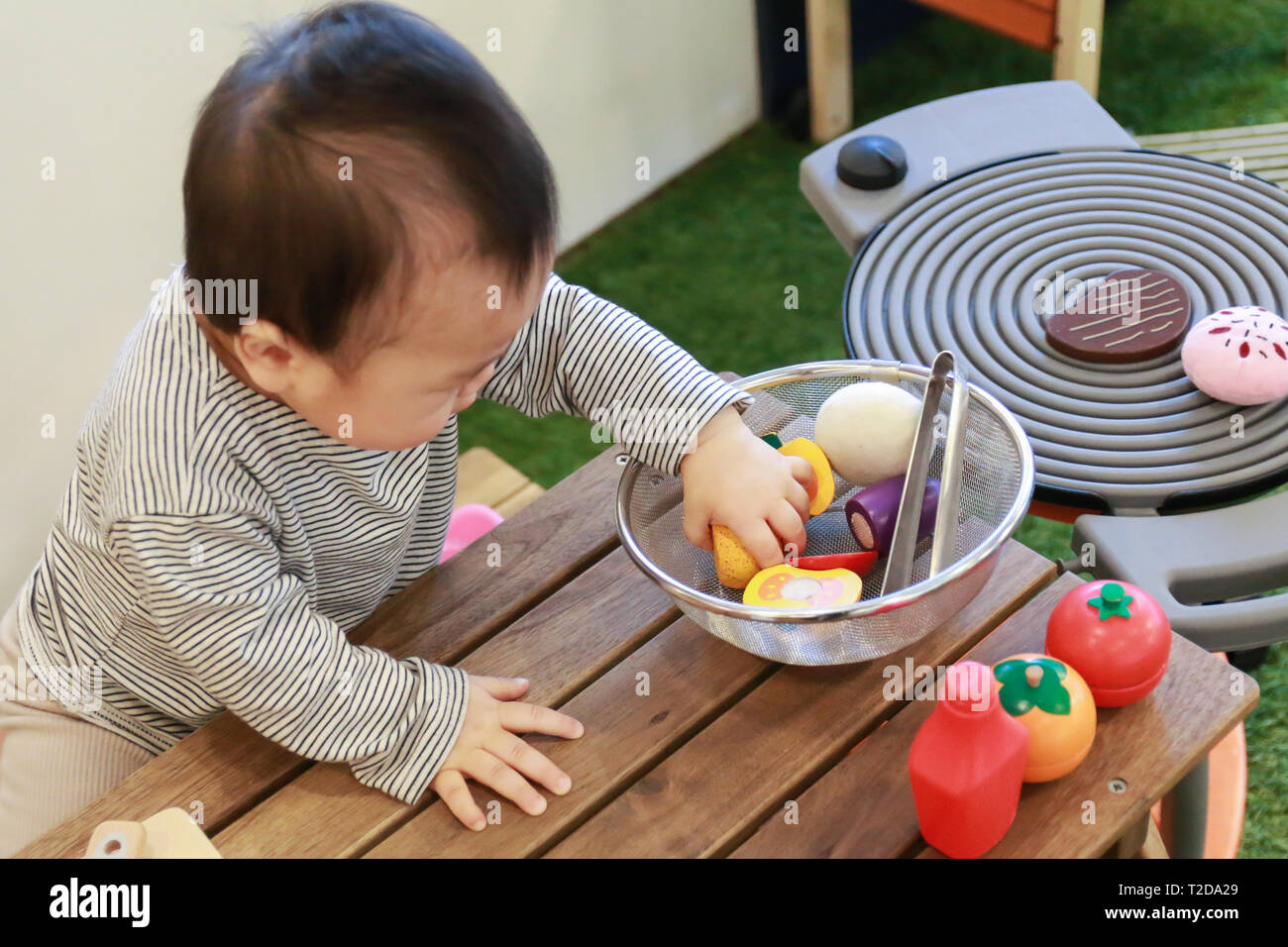 Asian family with baby in kitchen hires stock photography and images