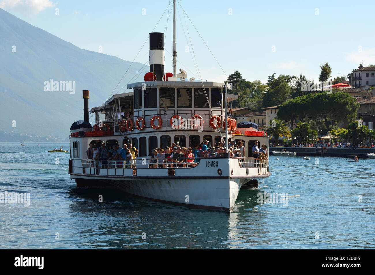 Passenger ship on the Lake Garda on the coast in front of Malcesine - Italy. Stock Photo