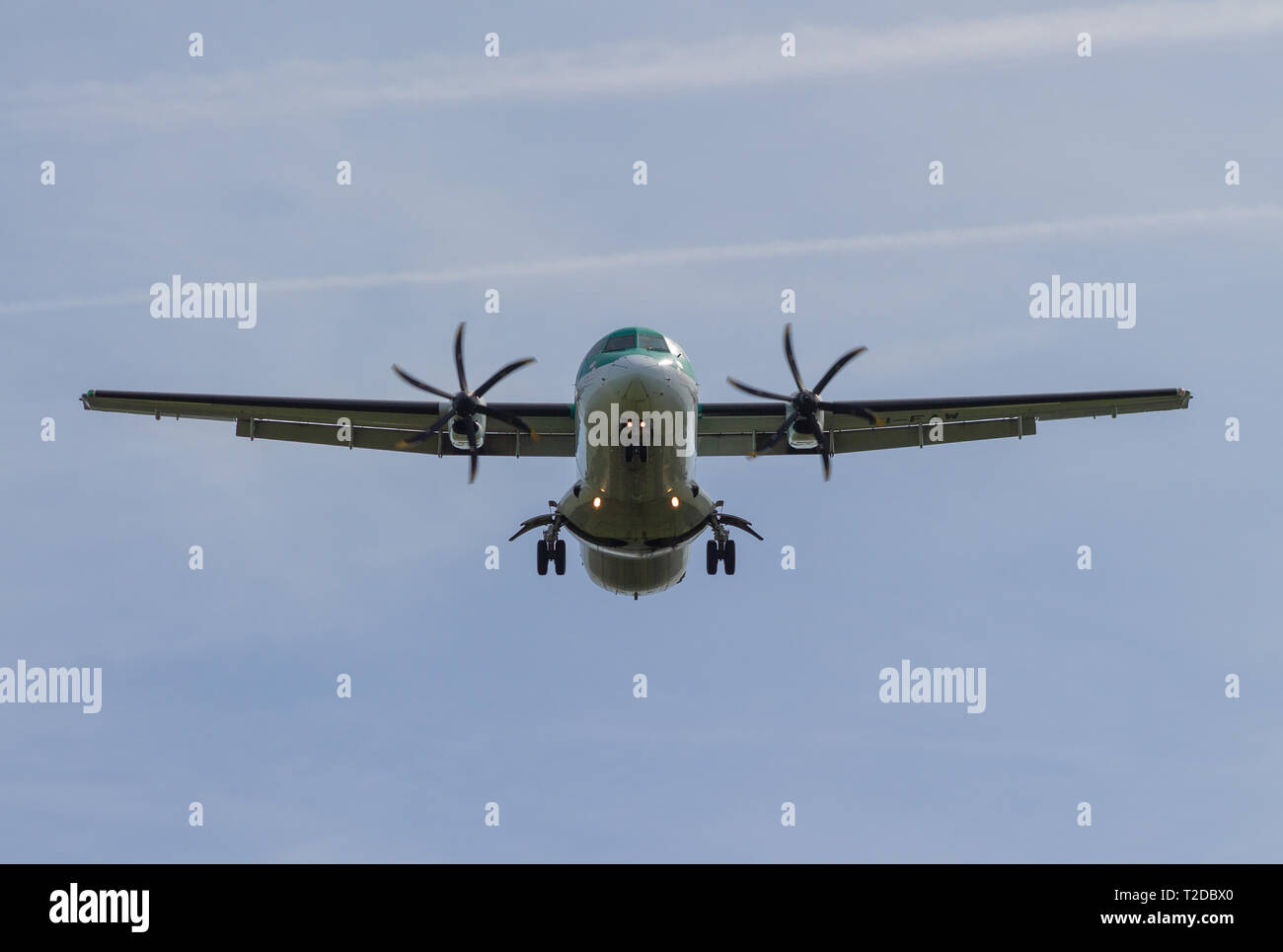 Air Lingus ATR Turbo Prop plane landing with landing gear down and flaps extended at Cork Airport Stock Photo