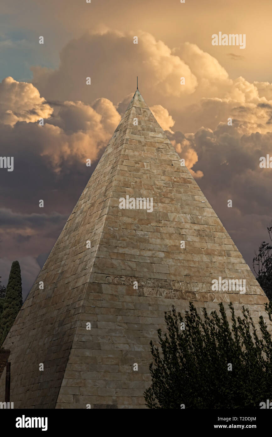 Rome, Italy, Piramide Cestia Pyramid of Cestius, on a background of cloudy sky Stock Photo