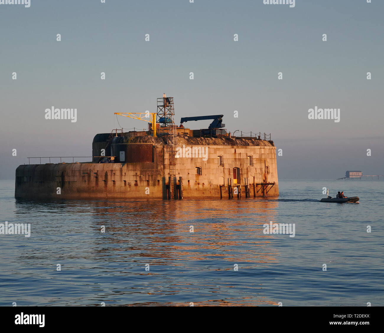 The 1860s granite and iron built St Helens Sea Fort bathed in sunset lighting. Victorian engineering to defend the Royal Navy fleet at anchor Stock Photo