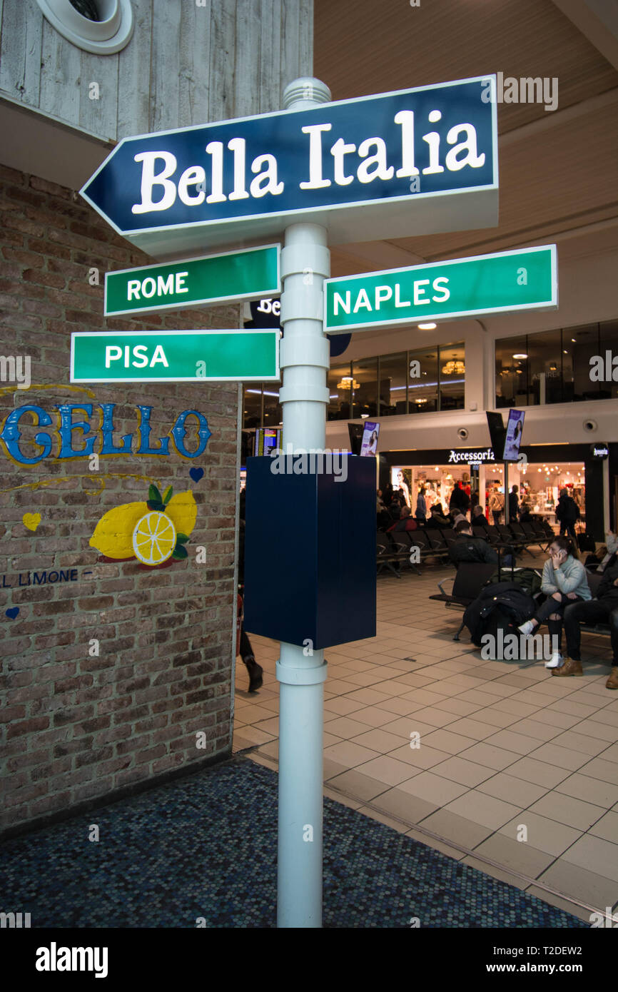 Bella Italia sign in Luton Airport signs outside eating area food and drink bar shop shops sit sitting designed design  lemon lemons wall art sitting Stock Photo