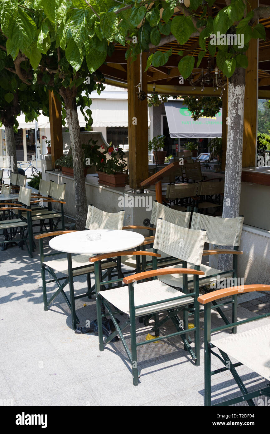 Street cafe with white tables and chairs in Olimpia Stock Photo