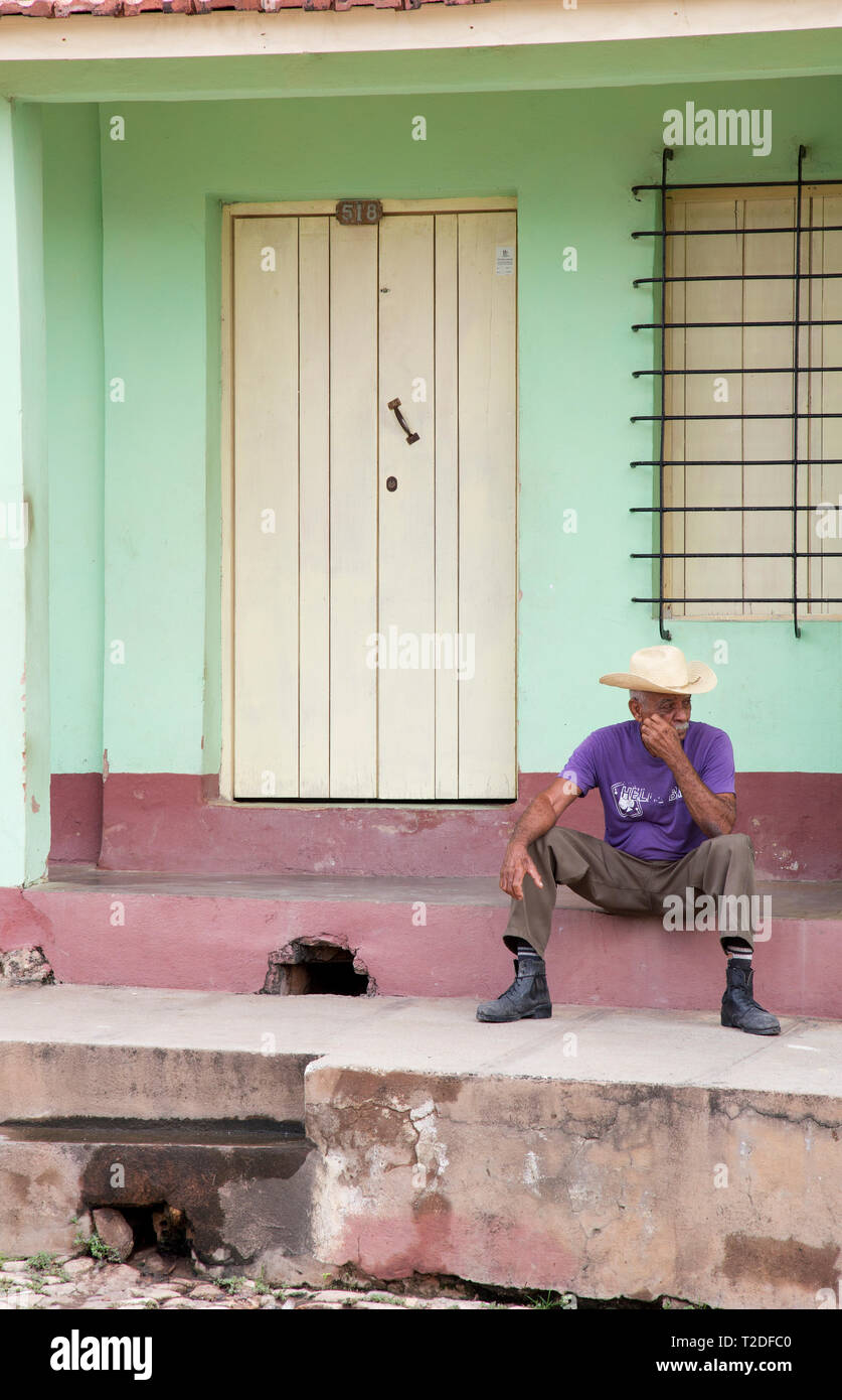 Cuban man relaxing in  street,Trinidad,Cuba Stock Photo