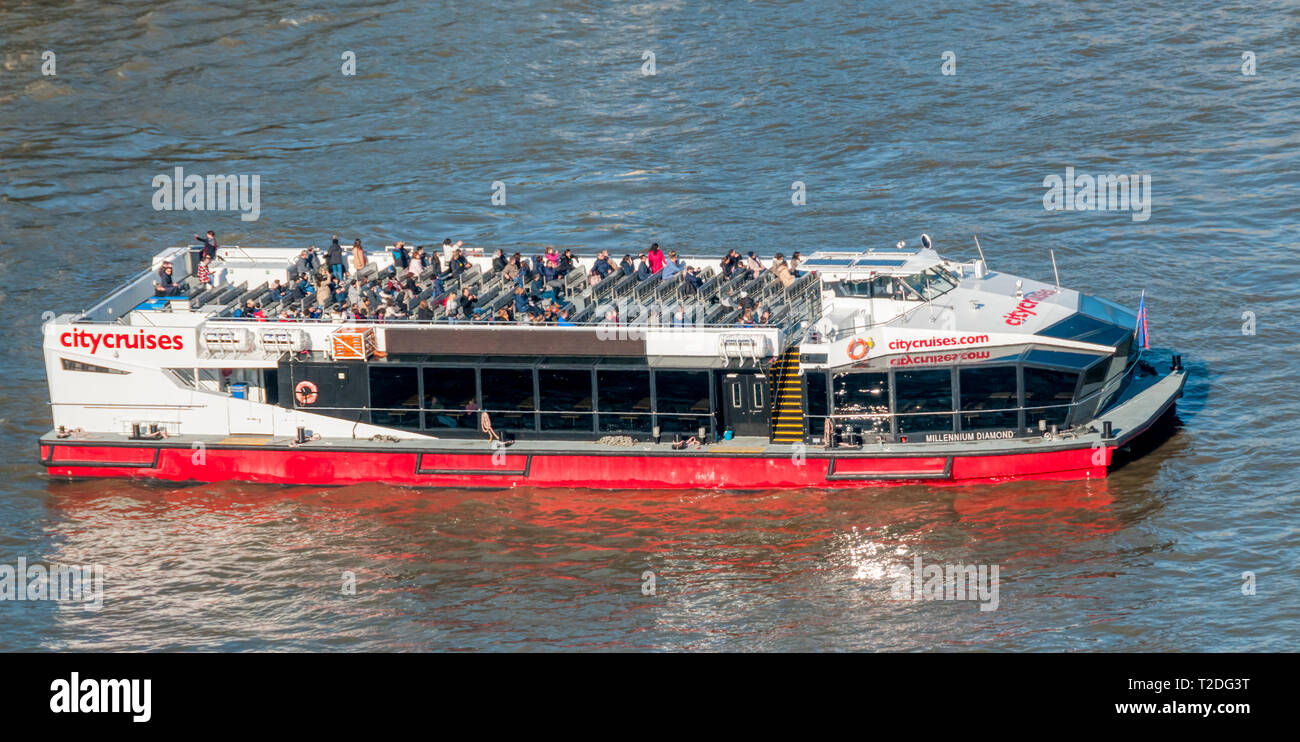 Tourists aboard City Cruises flagship vessel Millennium Diamond on the River Thames. Stock Photo