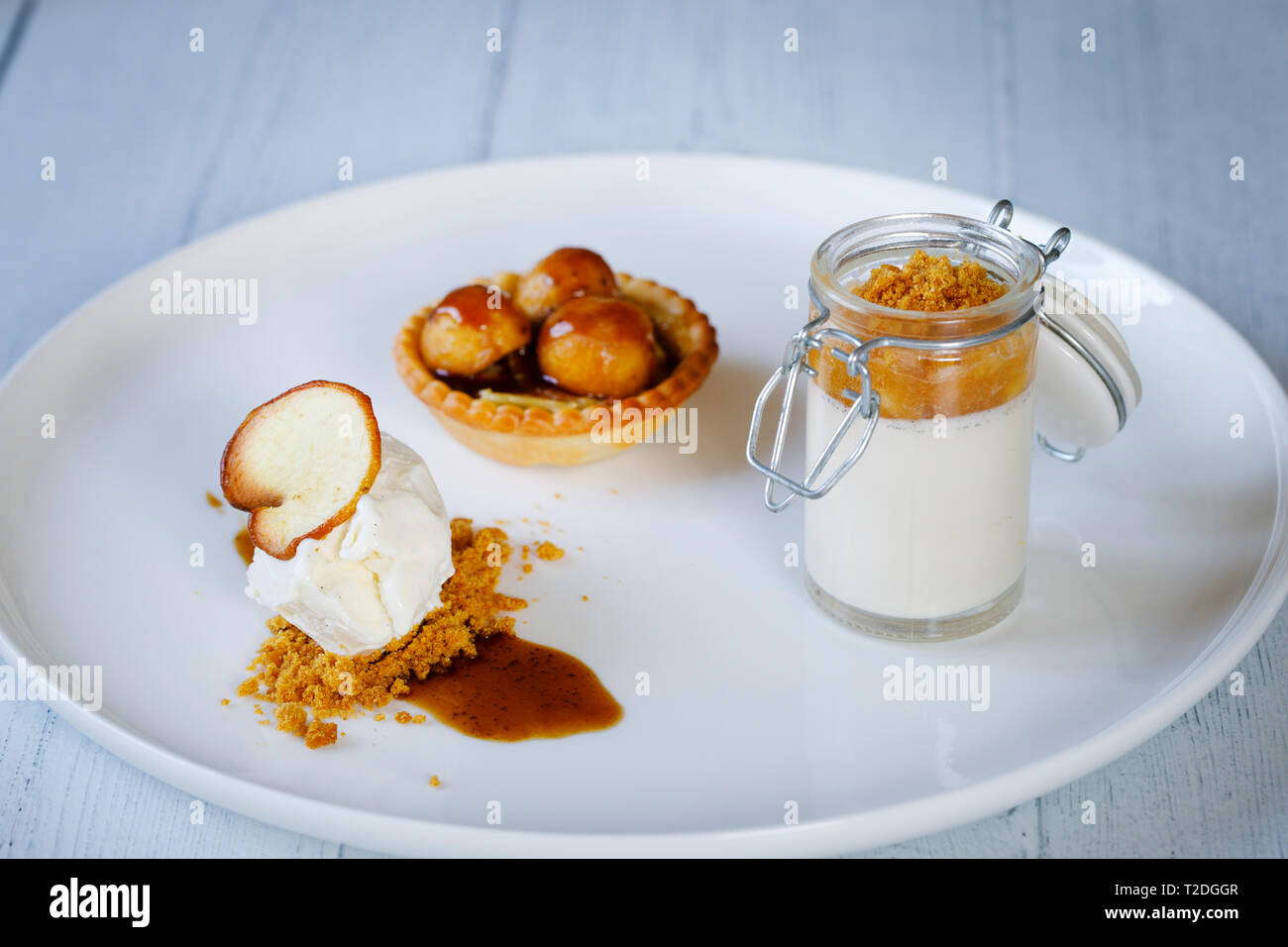 Trio of desserts, panna cotta, ice cream and apple tart Stock Photo