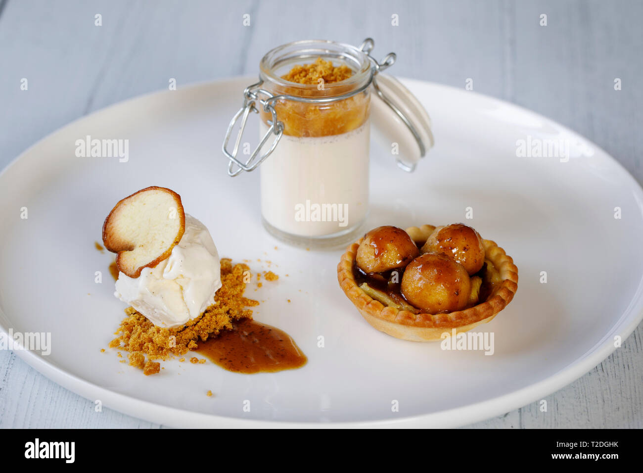 Trio of desserts, panna cotta, ice cream and apple tart Stock Photo