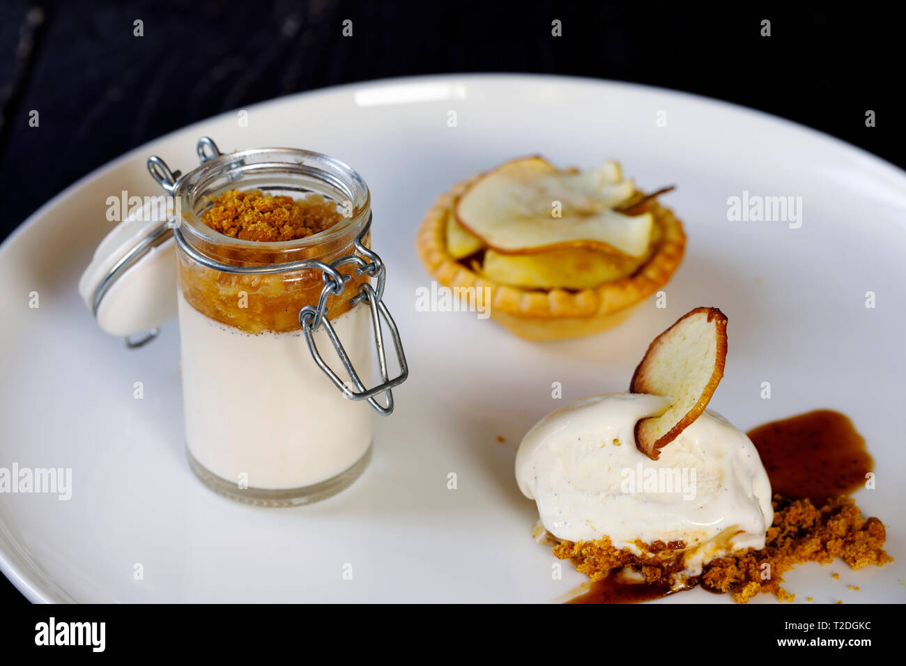 Trio of desserts, panna cotta, ice cream and apple tart Stock Photo