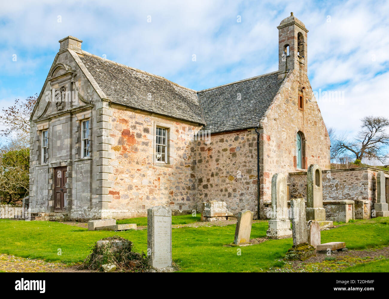 12th century Morham Parish Church and old graveyard with worn gravestones, East Lothian, Scotland, UK Stock Photo