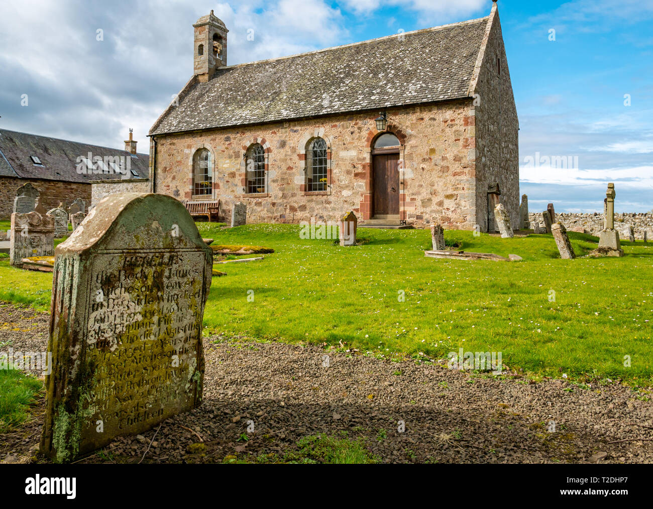 12th century Morham Parish Church and old graveyard with worn gravestones, East Lothian, Scotland, UK Stock Photo