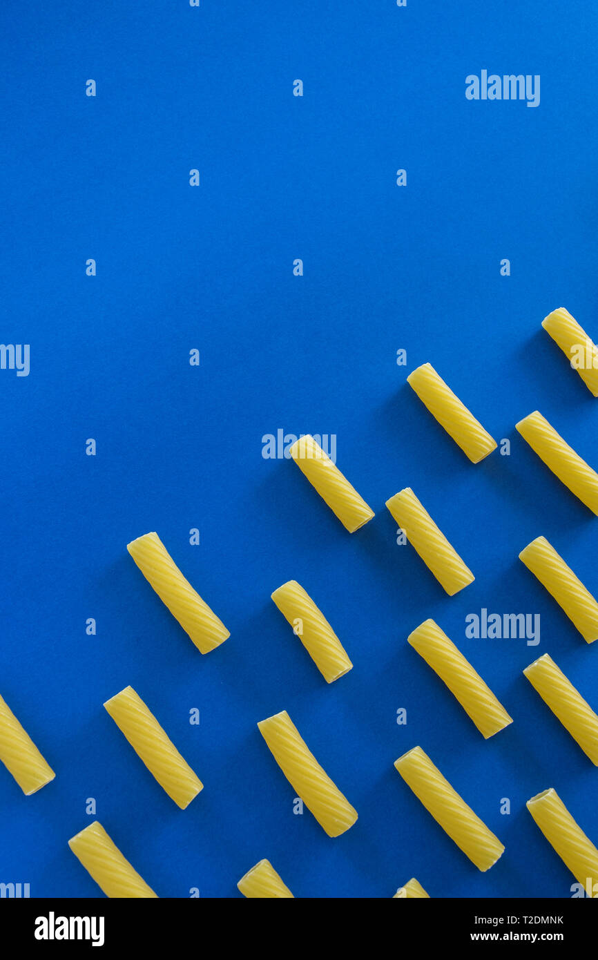 Abstract food background, Italian pasta products on blue background ...