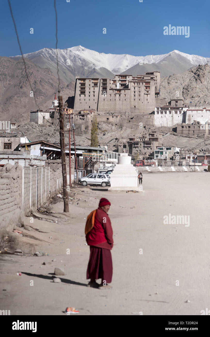 A monk walks towards the old Palace in the Himalayan mountain town of Leh, Ladakh, Jammu and Kashmir. India. Stock Photo