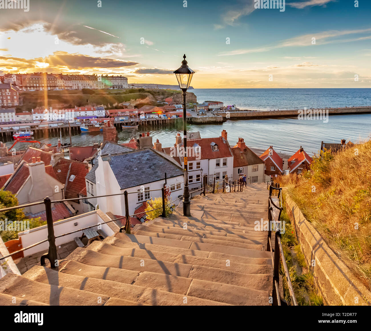 Sunset over the 199 steps at Whitby, North Yorkshire coast, England Stock Photo