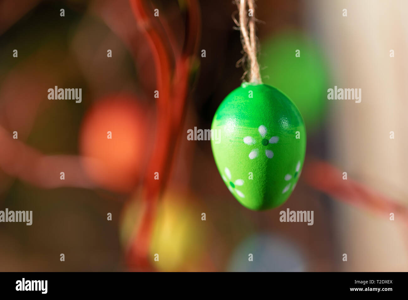 Hanging Easter eggs on tree with soft focus bokeh and color toned. Spring easter concept background. Stock Photo