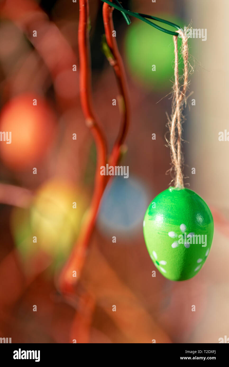 Hanging Easter eggs on tree with soft focus bokeh and color toned. Spring easter concept background. Stock Photo