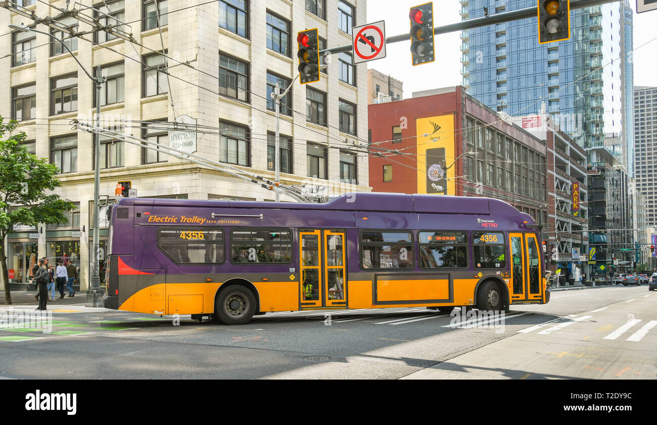 SEATTLE, WASHINGTON STATE, USA - JUNE 2018: Zero emissions electric trolley bus turning a corner on a street in Seattle city centre. Stock Photo