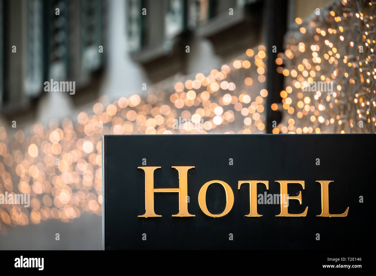 Hotel sign at dusk - Illuminated hotel sign in Paris at night;  vacation accomodation and travel concept Stock Photo