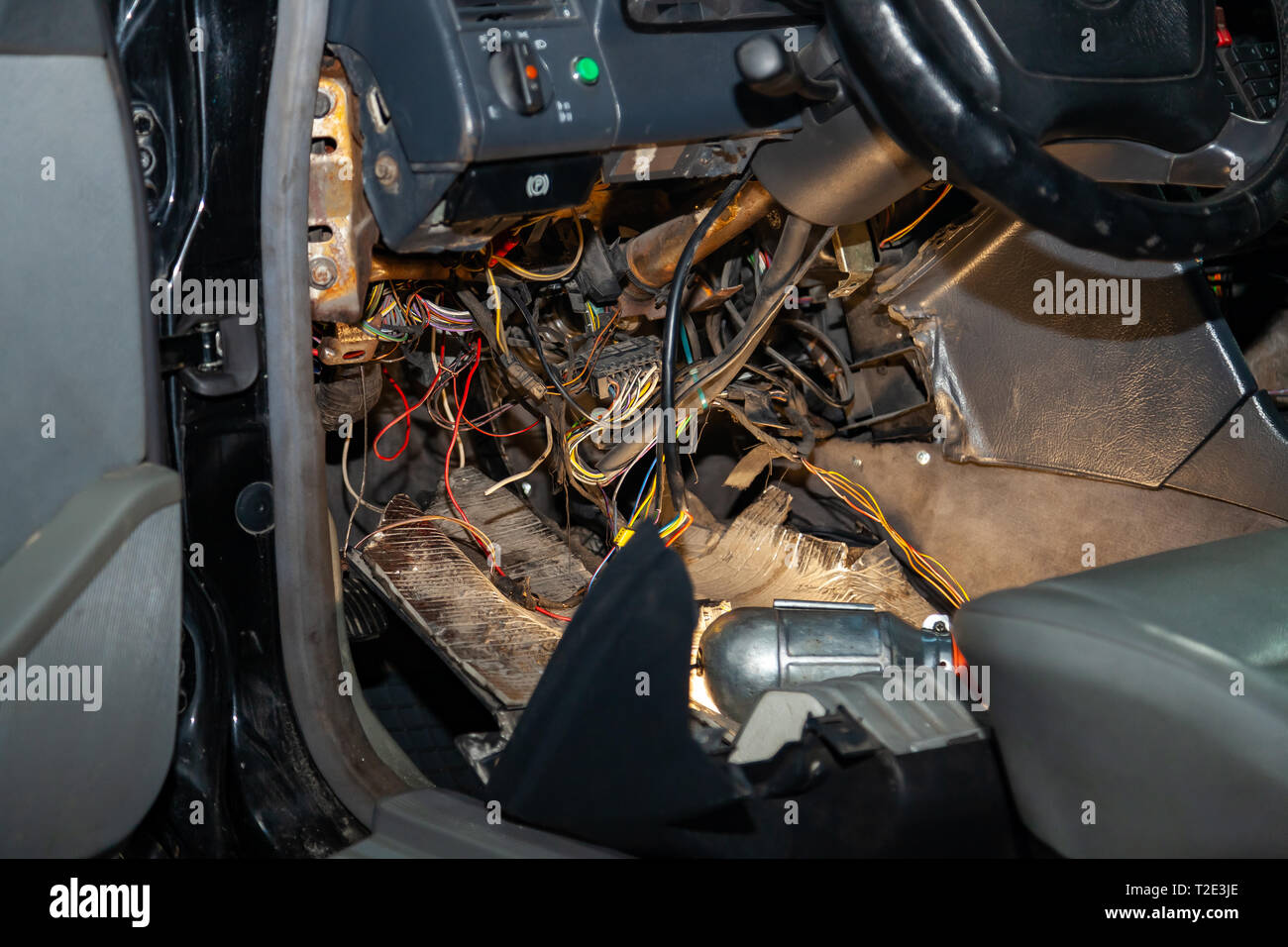 Automotive wiring under the wheel of an old German car, a disassembled