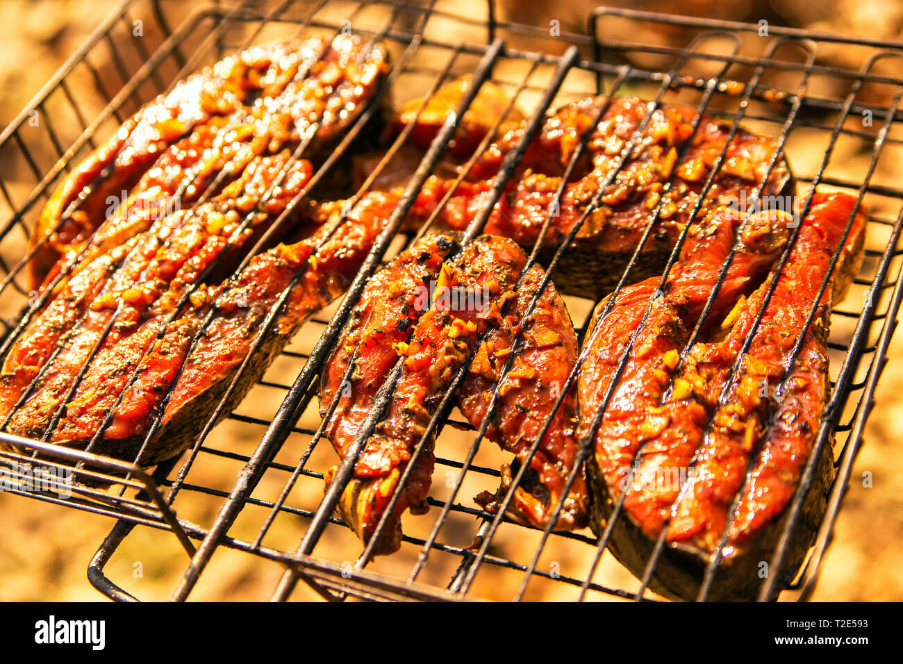 grilling salmon steak with ginger marinade in grid over barbecue. Top view  grilled salmon on flaming braai Stock Photo - Alamy