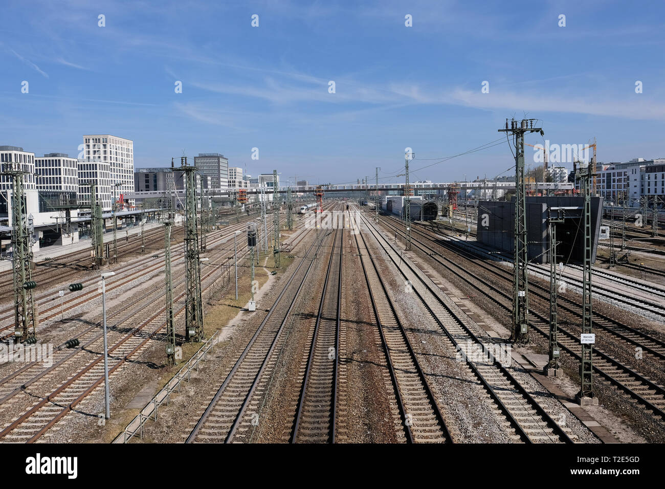 View towards main station in Munich with trails and power supply lines and graffiti in foreground Stock Photo