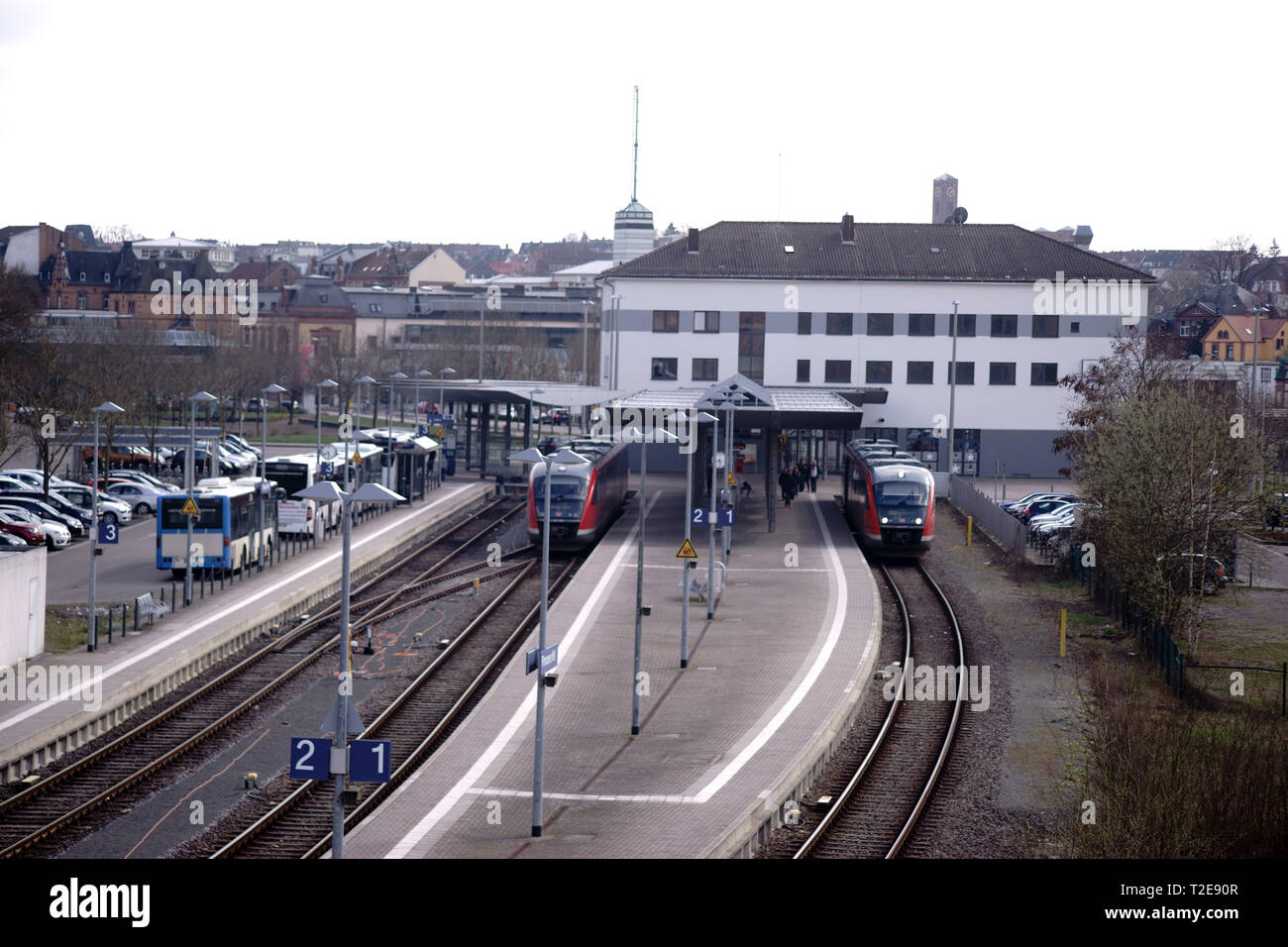 Pirmasens, Germany - March 26, 2019: Side by side tracks as well as platforms of the station Pirmasens with a modern station building on March 26, 201 Stock Photo