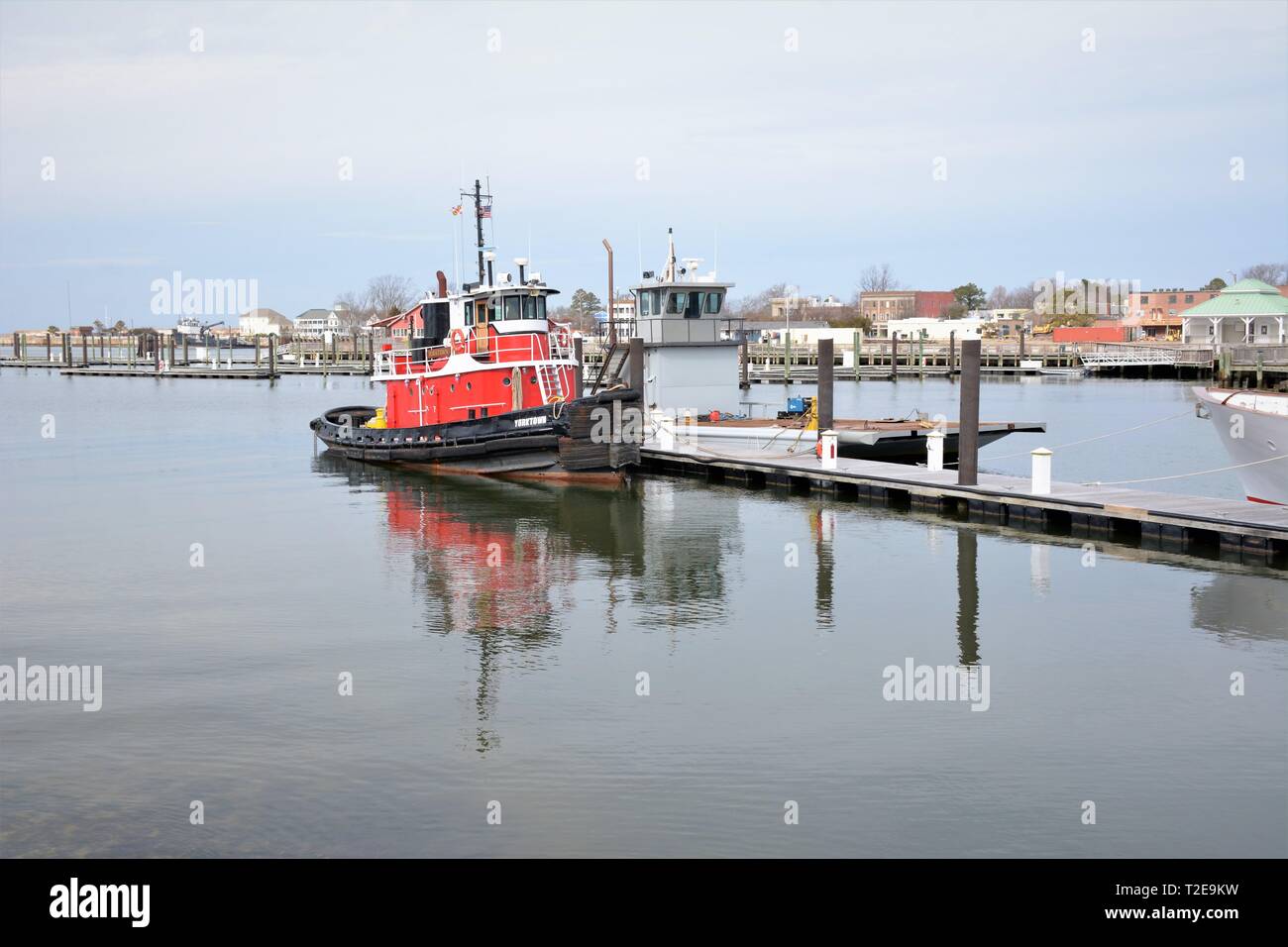 Real red tug boat docked at Cape Charles Virginia USA in fishing and container public boating