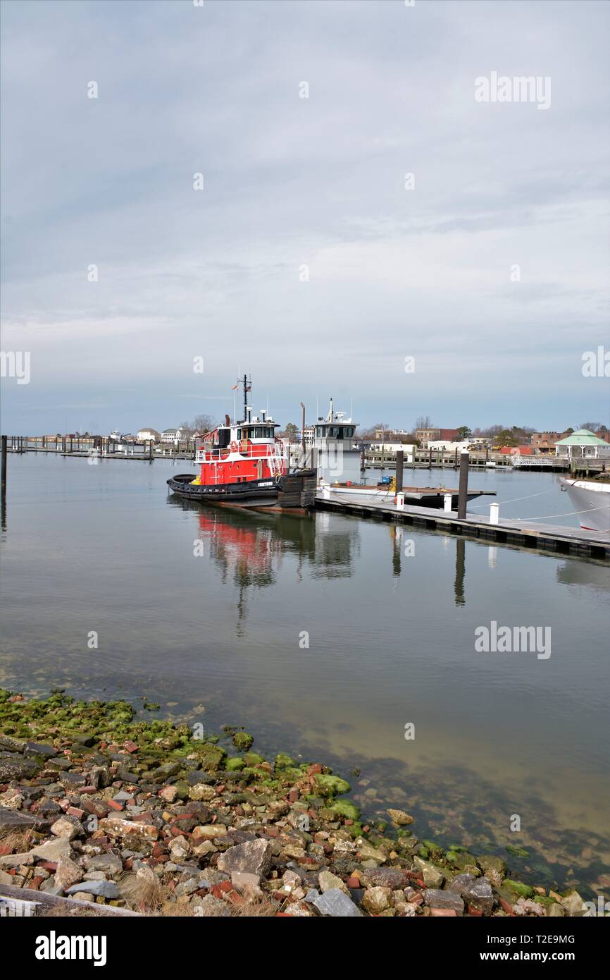 Real red tug boat docked at Cape Charles Virginia USA in fishing and container public boating