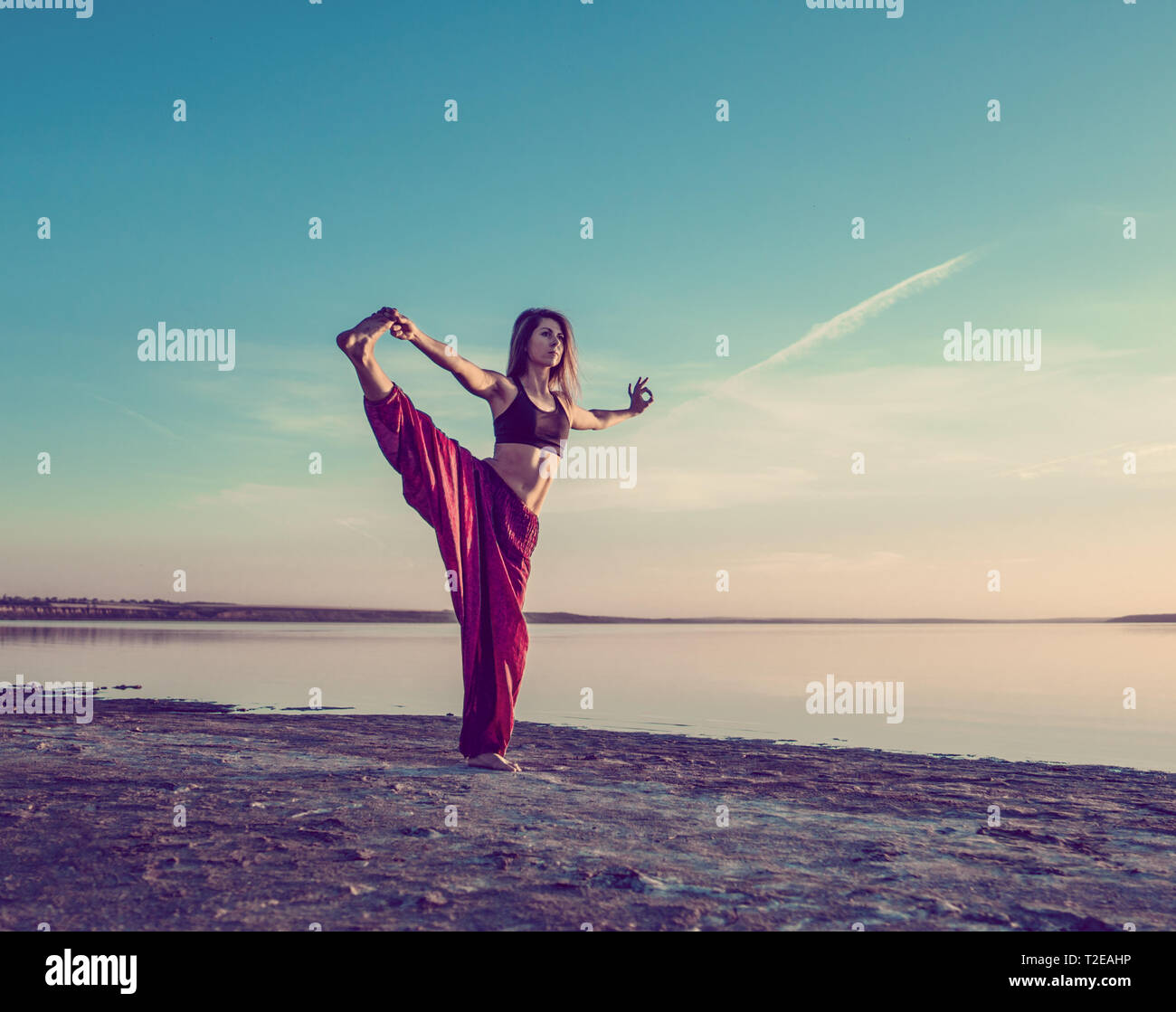 yoga woman on the beach at sunset. Stock Photo
