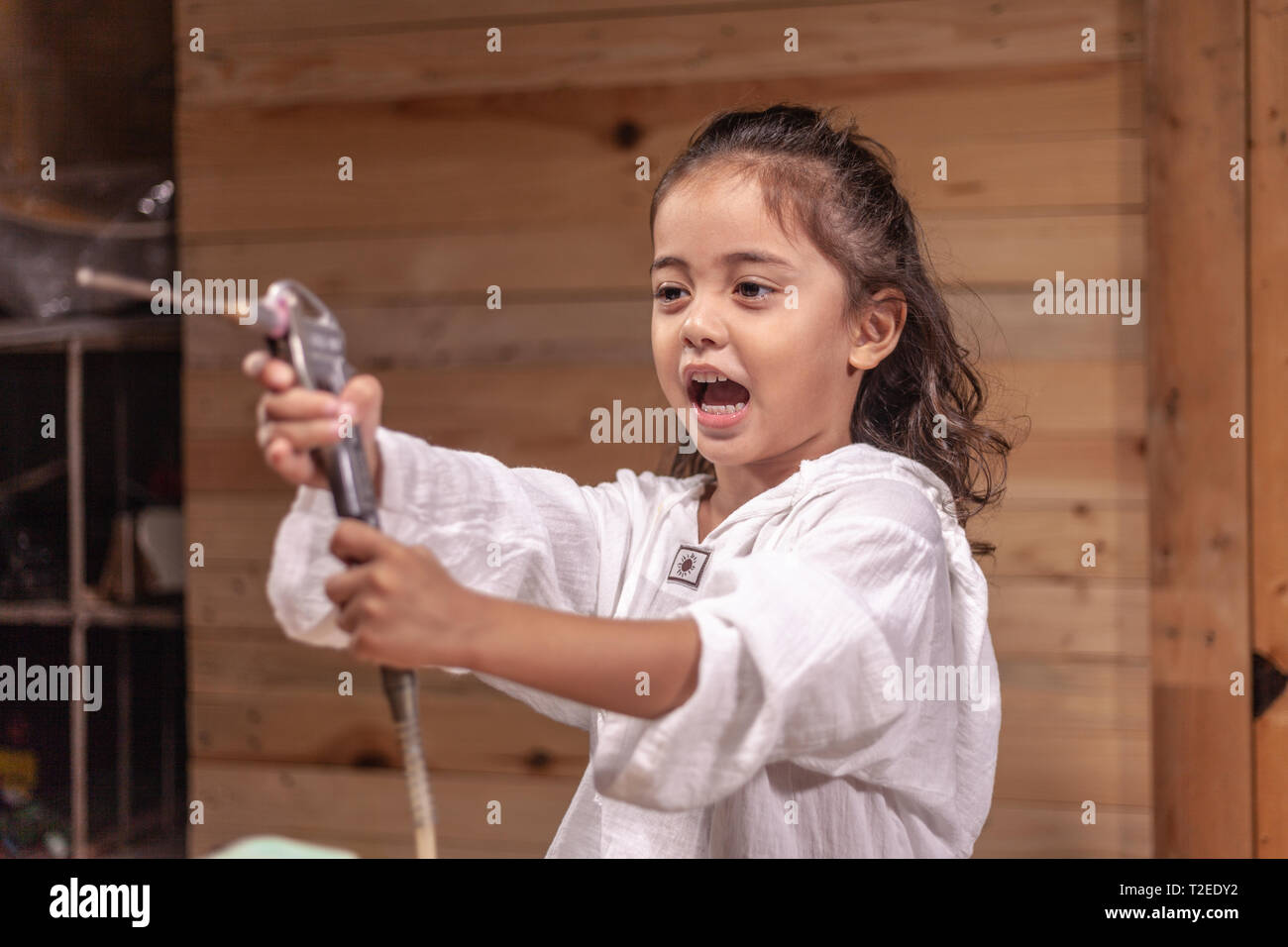 A Long Haired Boys Are Enjoying Using An Air Pump To Blow Powder