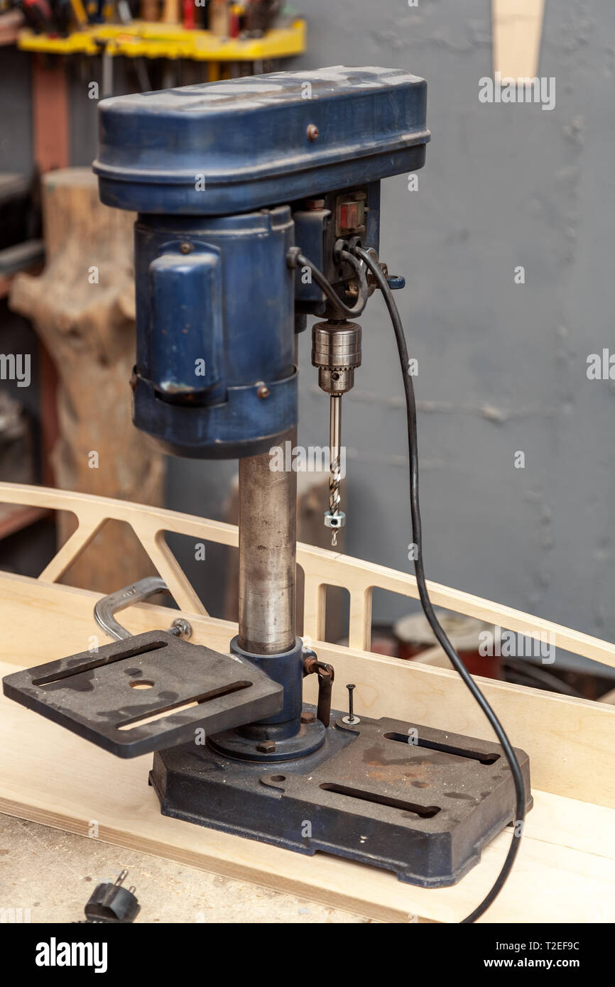 Industrial Iron drill ready for work in workshop interior. Close
