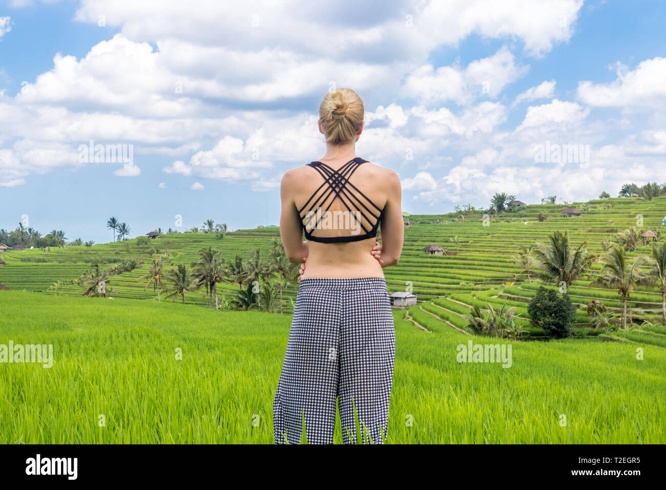 Relaxed sporty female traveler enjoying pure nature at beautiful Jatiluwih  rice fields on Bali. Concept of sustainable tourism, nature enjoyment, bala  Stock Photo - Alamy