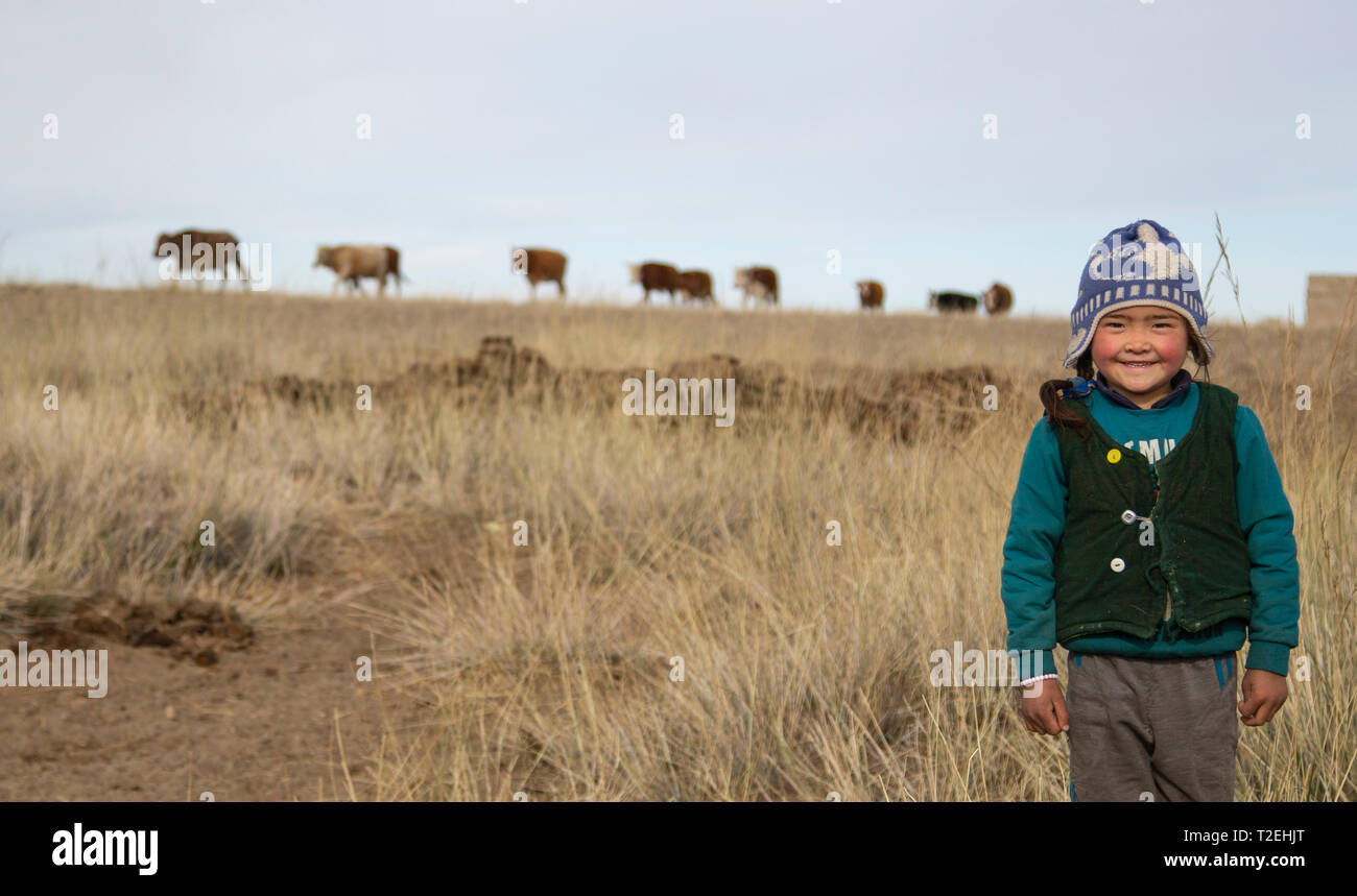 bayan Ulgii, Mongolia, 2nd October 2015: kazak girl playing outdoors in Western Mongolia Stock Photo