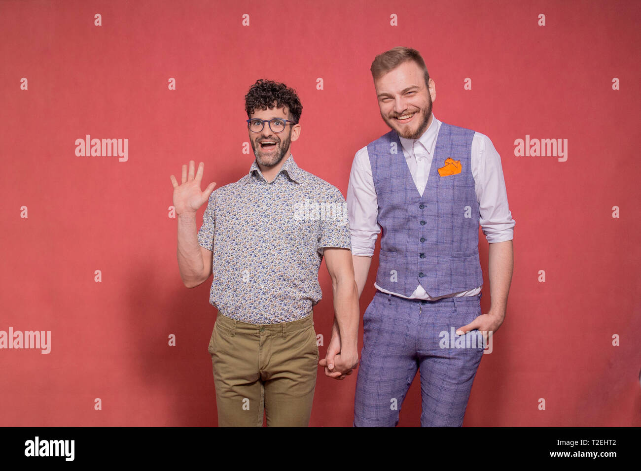 gay couple, acting funny in front of camera, looking directly to it.  hilarious and silly face expression, while smiling. Saying: Yes we are gay!  Stock Photo - Alamy