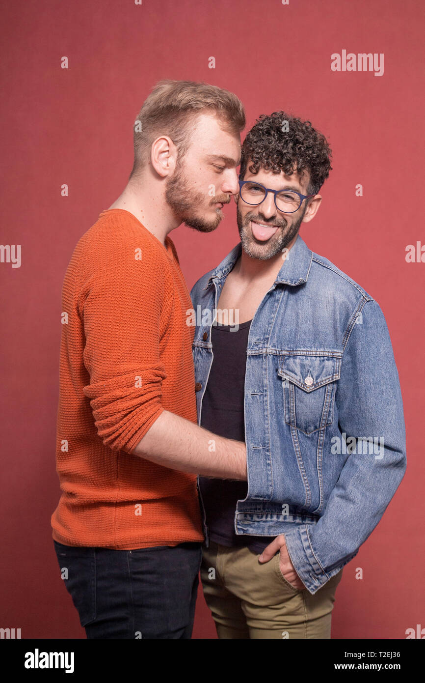 gay couple together, posing in front of camera, intimate with positive  emotions Stock Photo - Alamy
