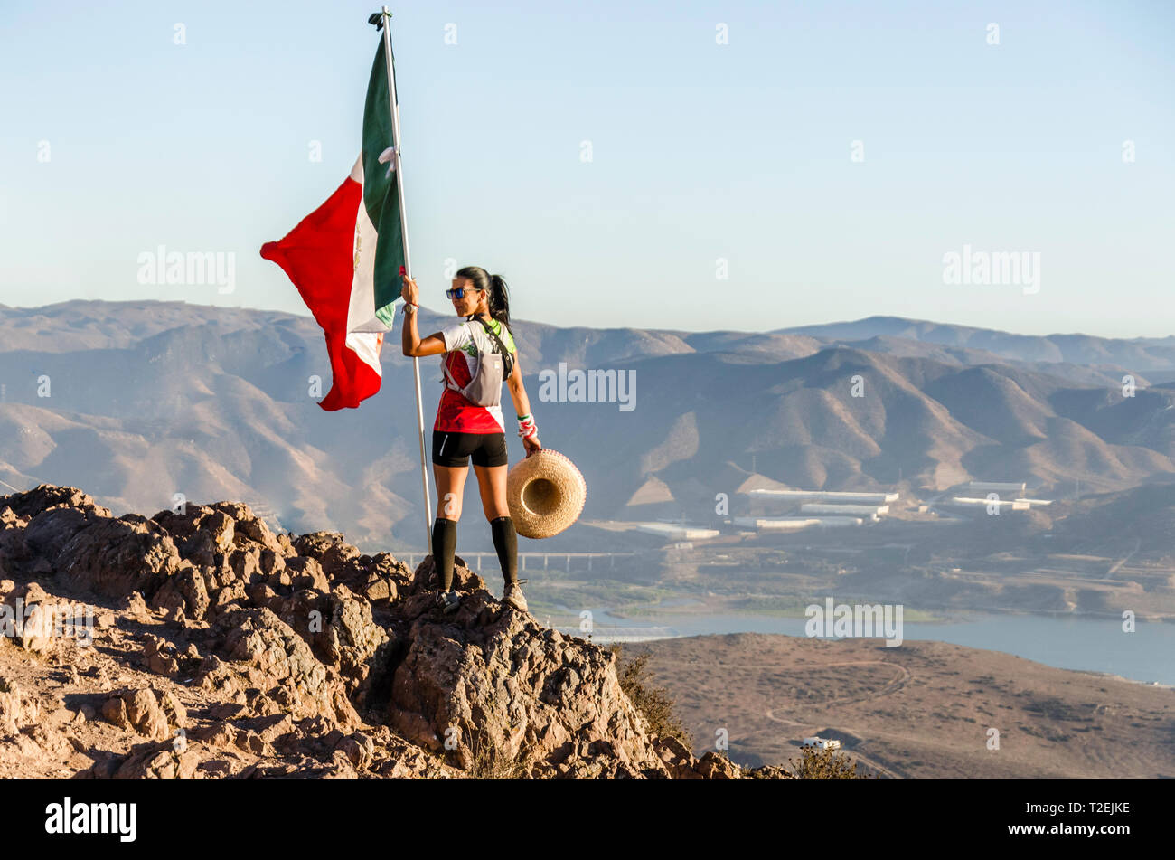 Hiker woman with flag Stock Photo