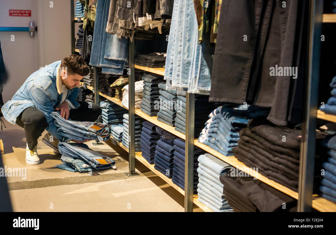 A sales associate adjusts the jean display in the Levi Strauss and Co.  flagship store in Times Square in New York on Tuesday, March 19, 2019 in  advance of their initial public