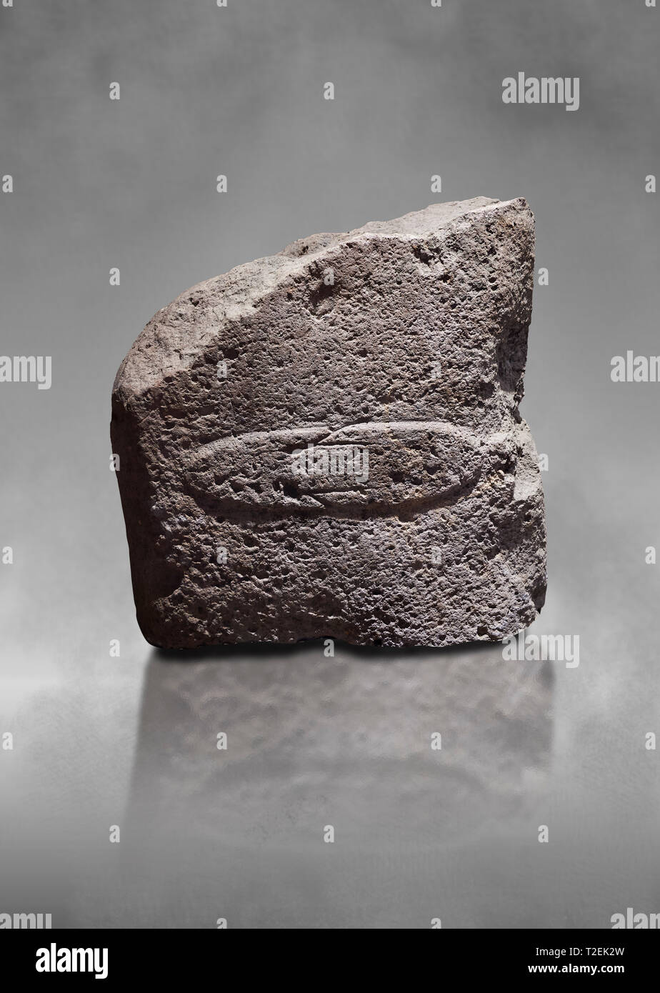 Fragment of a Late European Neolithic prehistoric Menhir standing stone with acarving of a horizontal knife on its face side.   Excavated from Montes  Stock Photo