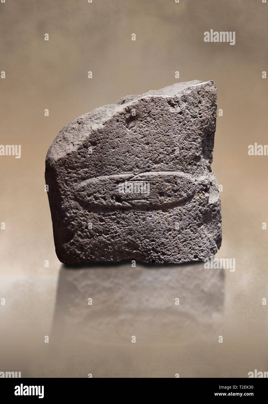 Fragment of a Late European Neolithic prehistoric Menhir standing stone with acarving of a horizontal knife on its face side.   Excavated from Montes  Stock Photo