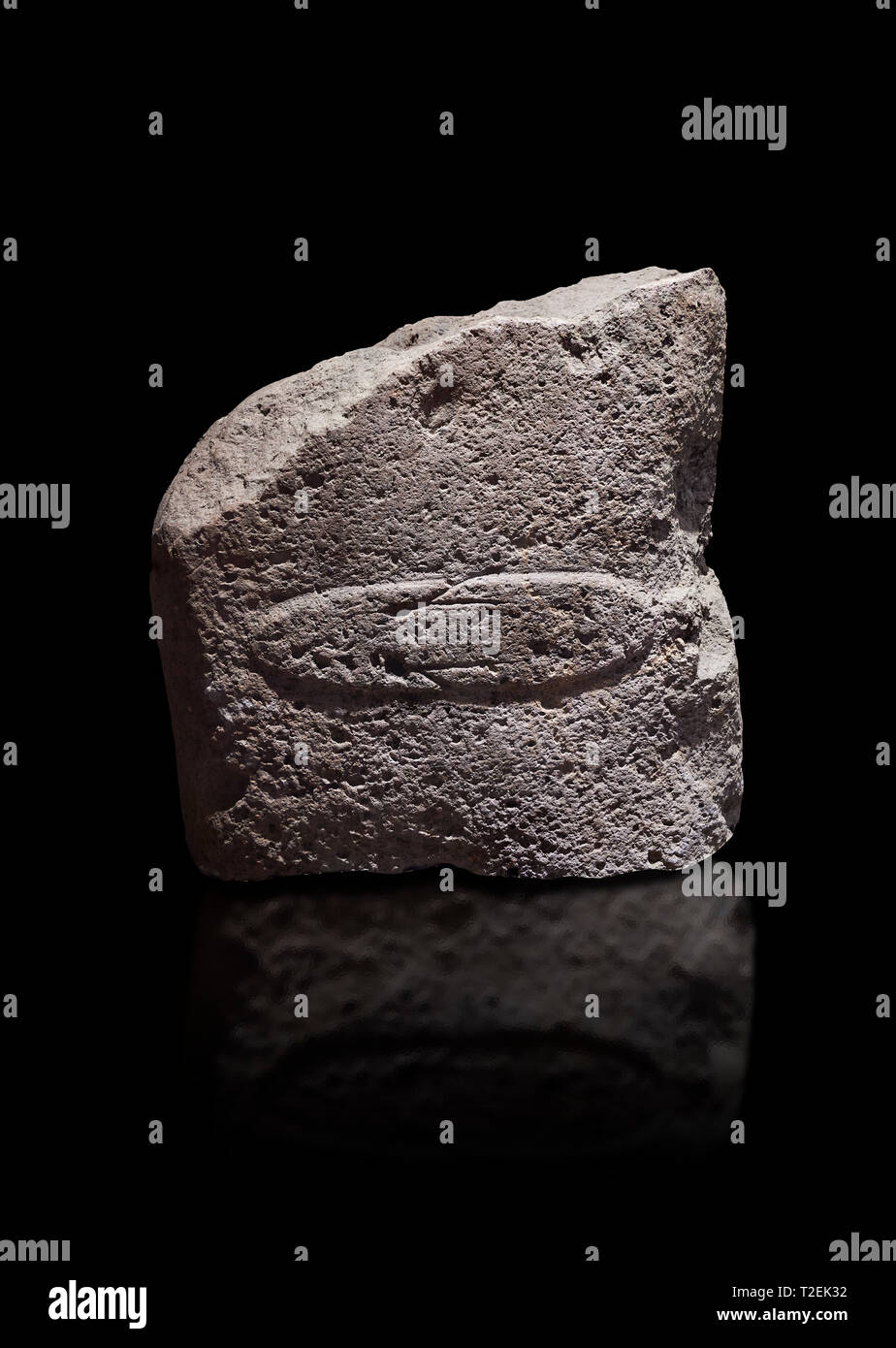 Fragment of a Late European Neolithic prehistoric Menhir standing stone with acarving of a horizontal knife on its face side.   Excavated from Montes  Stock Photo