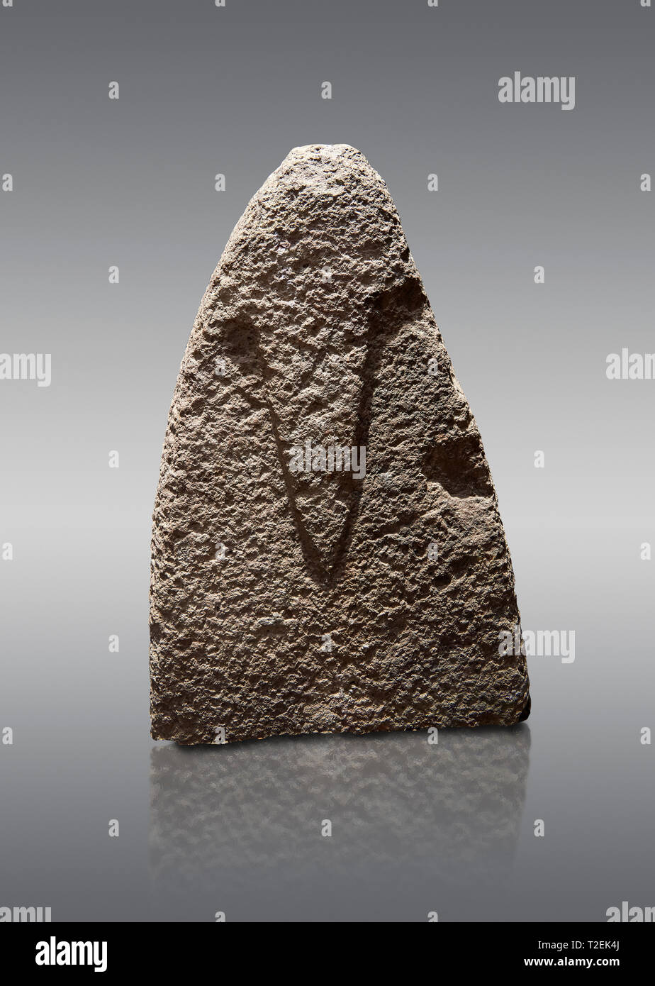 Top section of a Late European Neolithic prehistoric Menhir standing stone with carvings on its face side. The representation of a stylalised male fig Stock Photo