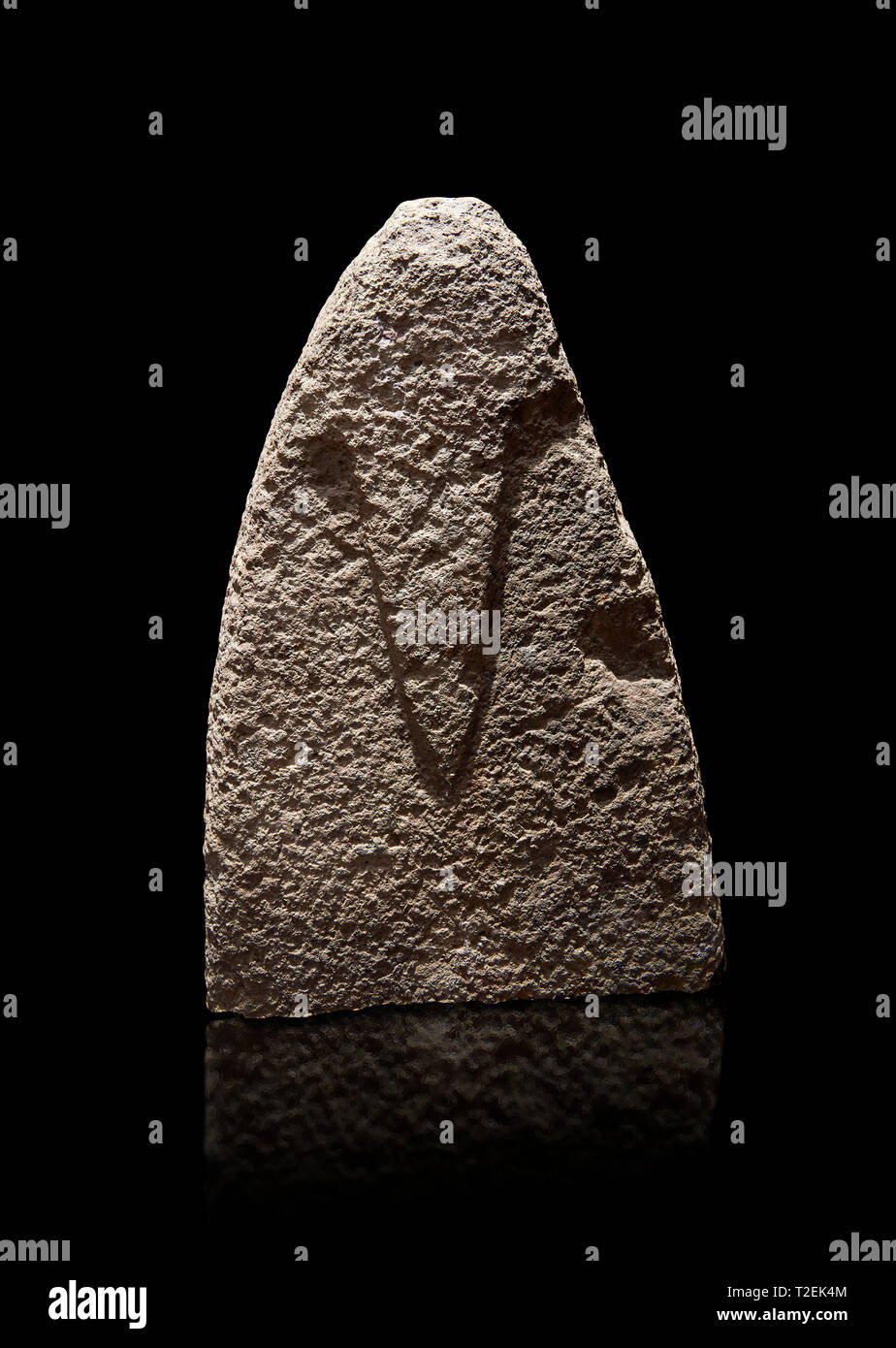 Top section of a Late European Neolithic prehistoric Menhir standing stone with carvings on its face side. The representation of a stylalised male fig Stock Photo